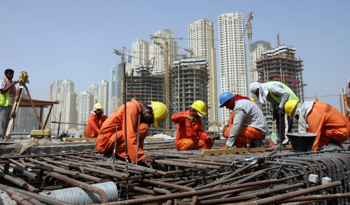 Asian workers at a construction site in Dubai. Many in the UAE’s labor force are migrants. (AFP file)