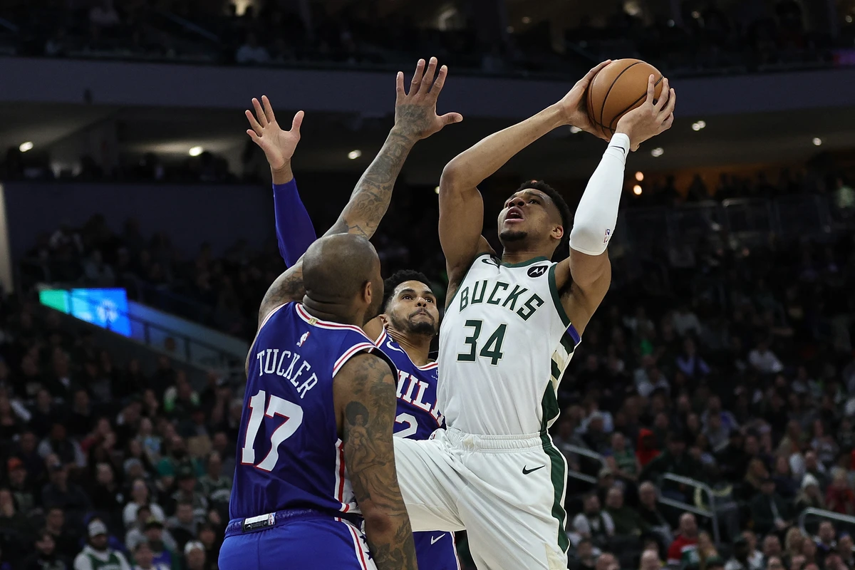 Giannis Antetokounmpo of the Milwaukee Bucks drives to the basket against Tobias Harris (12) and P.J. Tucker (17) of the Philadelphia 76ers during the first half of an NBA game at Fiserv Forum in Milwaukee, Wisconsin. (AFP)