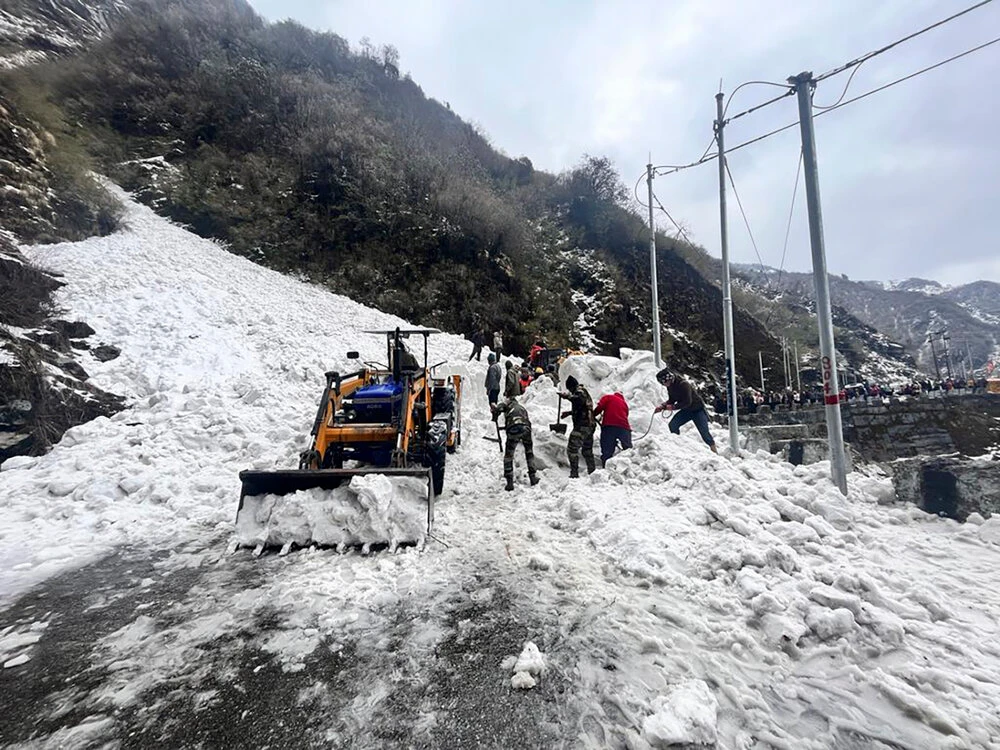 In this handout photo released by the Indian Army, soldiers clear snow from an avalanche near Nathu La mountain pass in India’s Sikkim state, on Apr. 4, 2023. (AP)