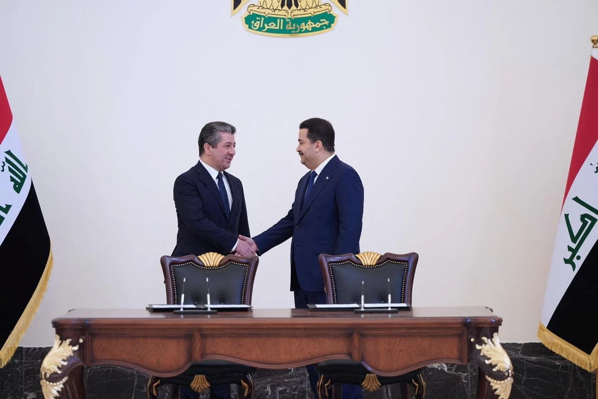 Iraqi Prime Minister Mohammed Shia Al-Sudani, right, and his Kurdish counterpart Masrour Barzani sign deal to restart northern oil exports in Baghdad on Tuesday. Reuters