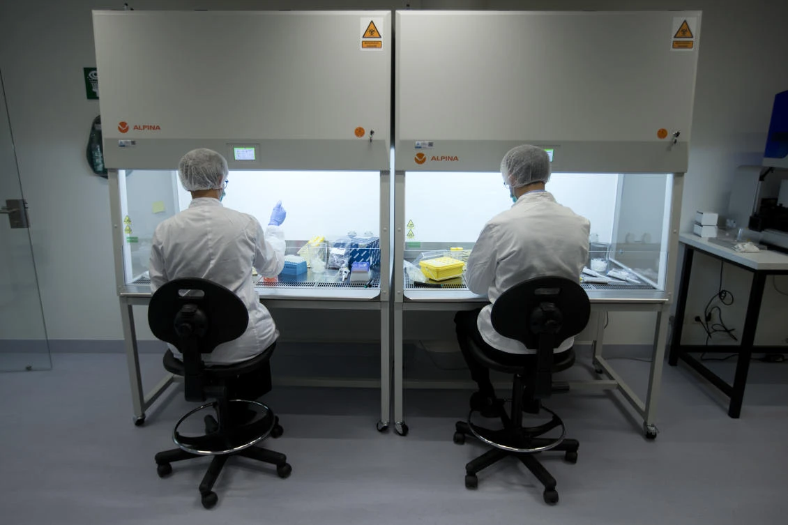 Employees demonstrate the technique of DNA sampling during a press tour of the DNA lab of the International Commission on Missing Persons, ICMP, at the occasion of the opening of their new office in The Hague on Oct. 24, 2017. (AP)