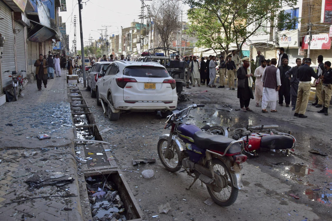 Police officers and people gather at the site of a bomb blast, in Quetta, Pakistan, Monday, April 10, 2023. (AP)