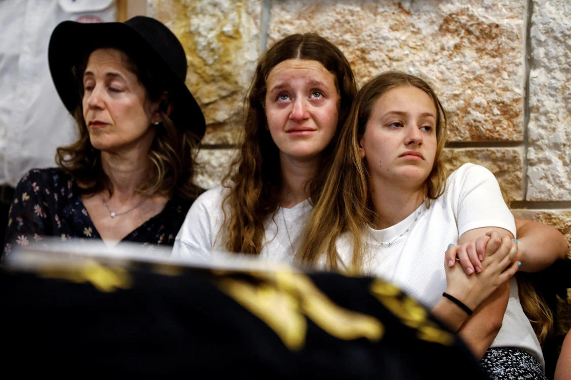 Sisters of Maia and Rina Dee, Israeli-British sisters killed in a shooting attack, mourn during their funerals at a cemetery in Kfar Etzion in the Israeli-occupied West Bank, April 9, 2023. (Reuters)
