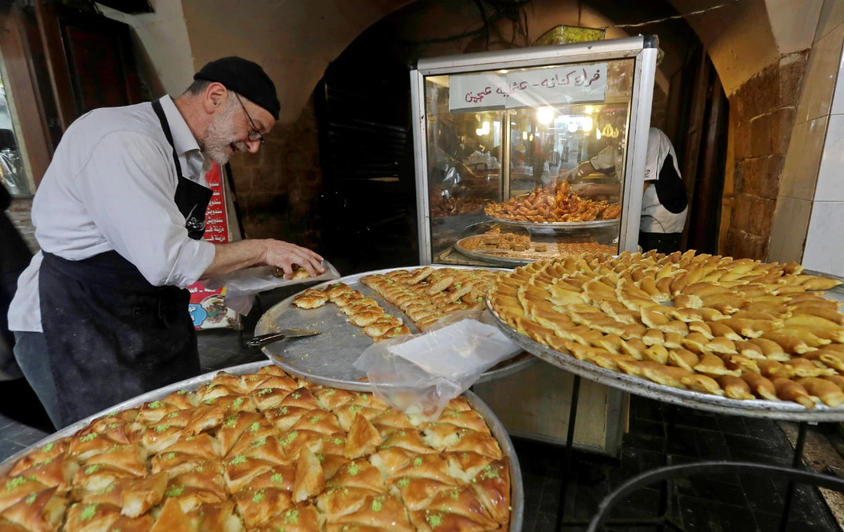 A vendor sells traditional sweets that are beloved during Ramadan at a market in Sidon, Lebanon. (AFP)