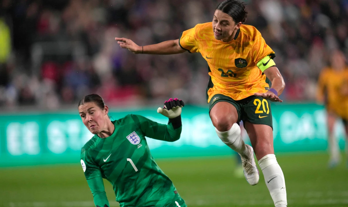 Australia's Sam Kerr, right, scores against England during the women's international friendly soccer match between England and Australia at the Gtech Community Stadium in London Tuesday. (AP)