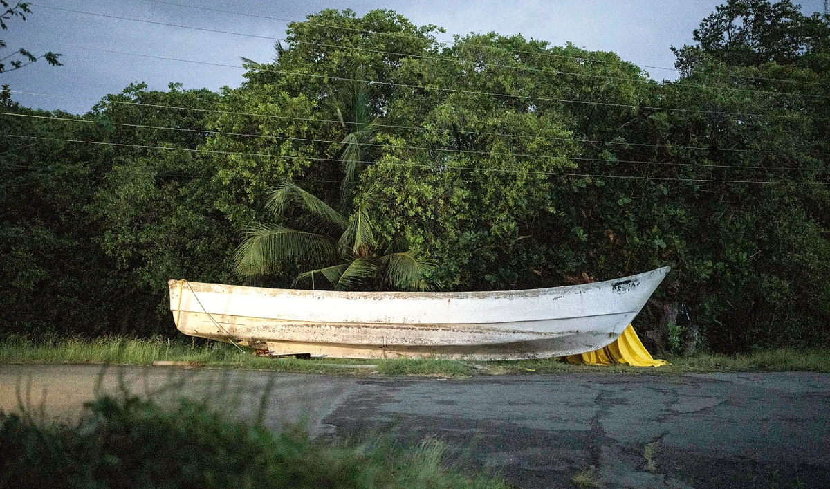 A traditional boat from Mauritania known as a pirogue sits by the side of the road in the village of Belle garden on the island of Trinidad and Tobago. (AP)