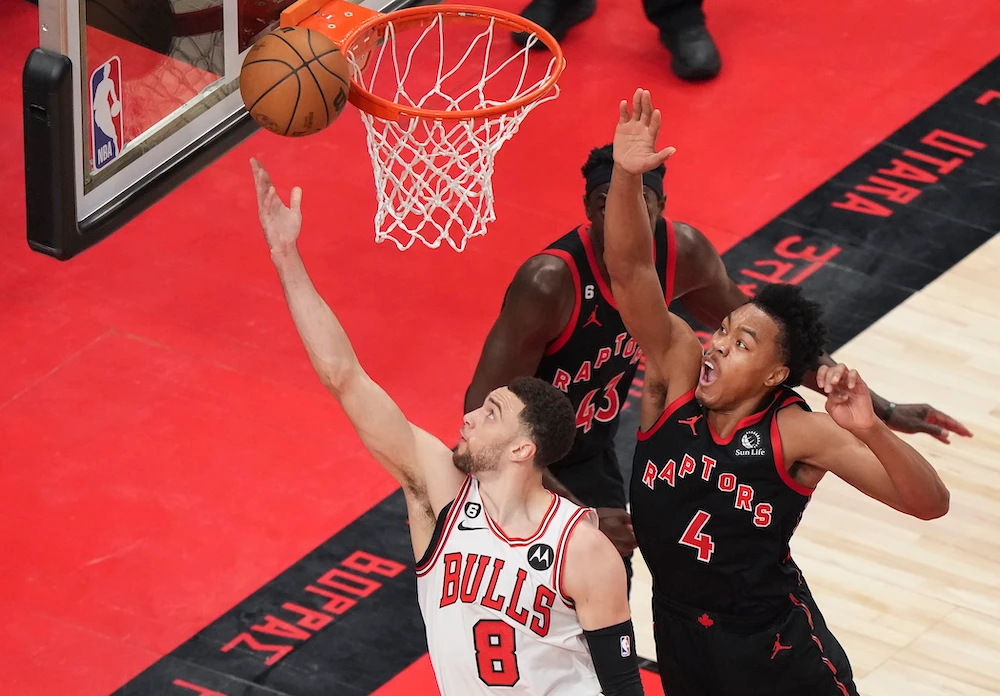Chicago Bulls guard Zach LaVine scores past Toronto Raptors forward Scottie Barnes during the first half of an NBA basketball play-in tournament game Wednesday in Toronto. (The Canadian Press via AP)