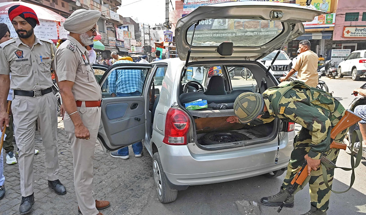 Border Security Force (BSF) personnel check a car along a street in Amritsar on April 13, 2023. (AFP/File)
