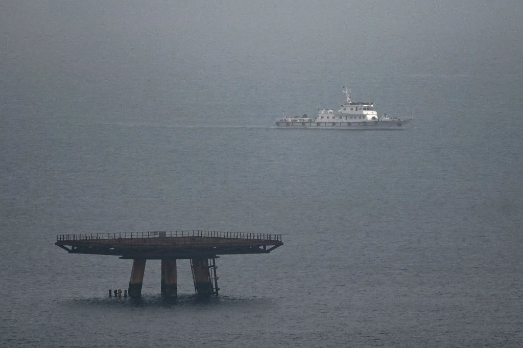 A lone ship (R) sits at the entrance to a bay where live fire exercises were being held on land on Pingtan island, the closest point in China to Taiwan, in southeast China’s Fujian province. (File/AFP)