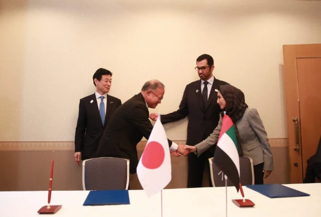 The UAE's Minister of Industry and Advanced Technology Dr Sultan Al Jaber and Japan's Minister of Economy, Trade and Industry Nishimura Yasutoshi witness the signing of the agreements (Twitter/@ADNOCGroup)
