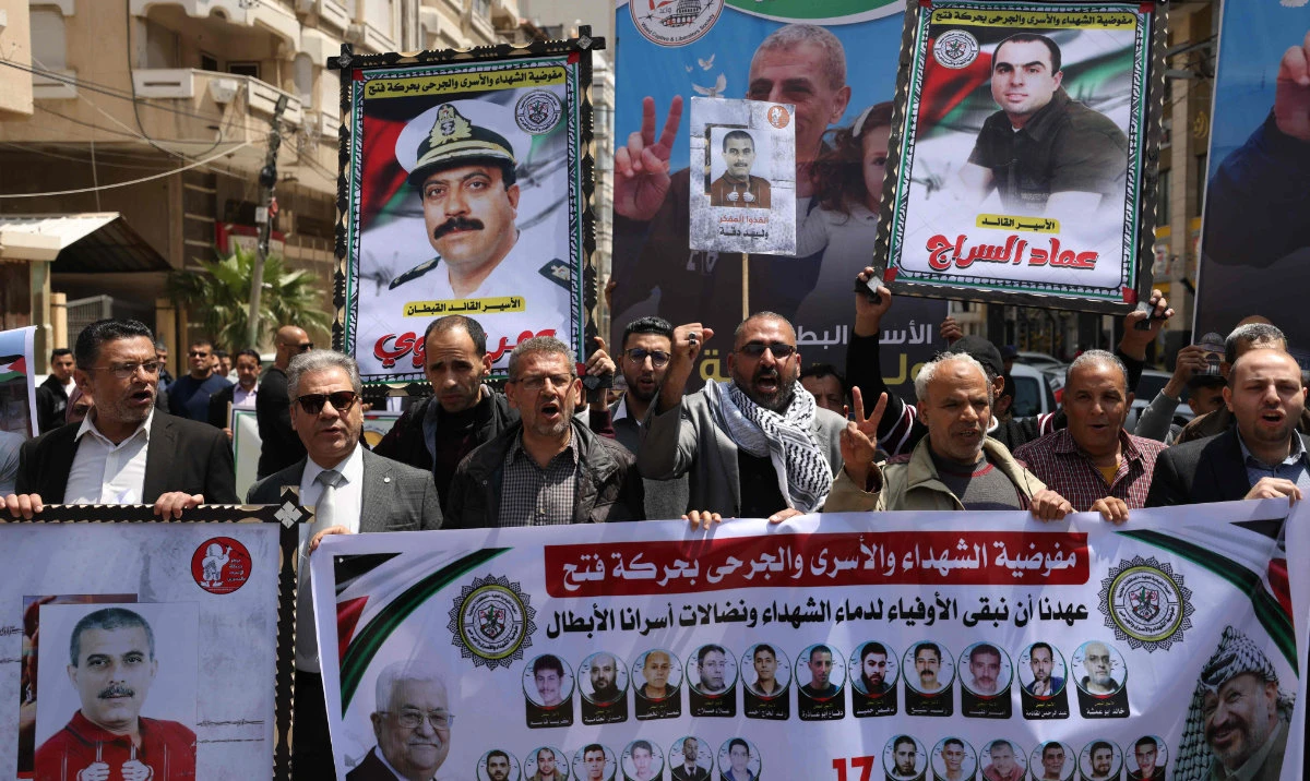 Protesters rally on Monday in solidarity with prisoners held in Israeli jails, outside the International Committee of the Red Cross office in Gaza City. (AFP)