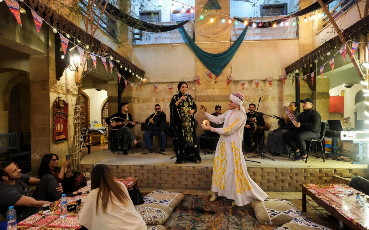 Shaimaa El Nouby, an Egyptian Islamic chanter performing Islamic religious songs, popularly known as “Inshad,” sings on stage with Wael El Fashny, during Ramadan at El-Rabaa Cultural Center event at Al Hussein in old Cairo on Apr. 14, 2023. (Reuters)