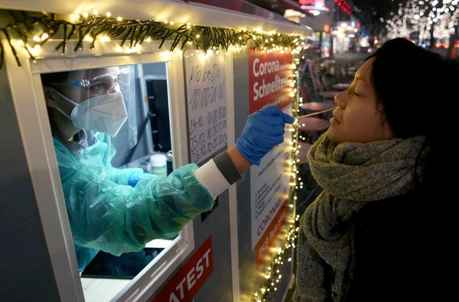 A health worker performs a coronavirus test at a shopping road in Berlin, Germany, on Dec. 21, 2021.(AP/File)