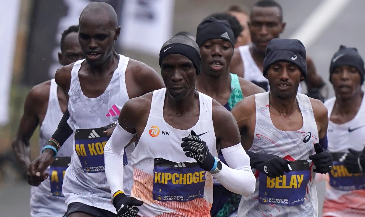 Eliud Kipchoge, of Kenya, center, runs ahead of Andualem Belay, of Ethiopia, second from right, at the front of a group of elite men, along the course of the 127th Boston Marathon Monday in Framingham, Mass. (AP)