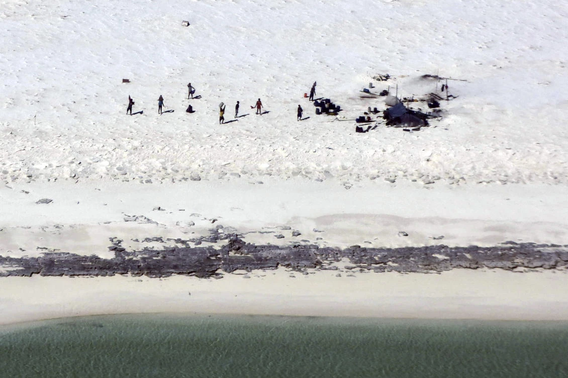 Fishermen from Indonesia stand on a beach on Bedwell Island, 313km west of Broome, Australia, on Monday, April 17, 2023. (Australian Maritime Safety Authority via AP)