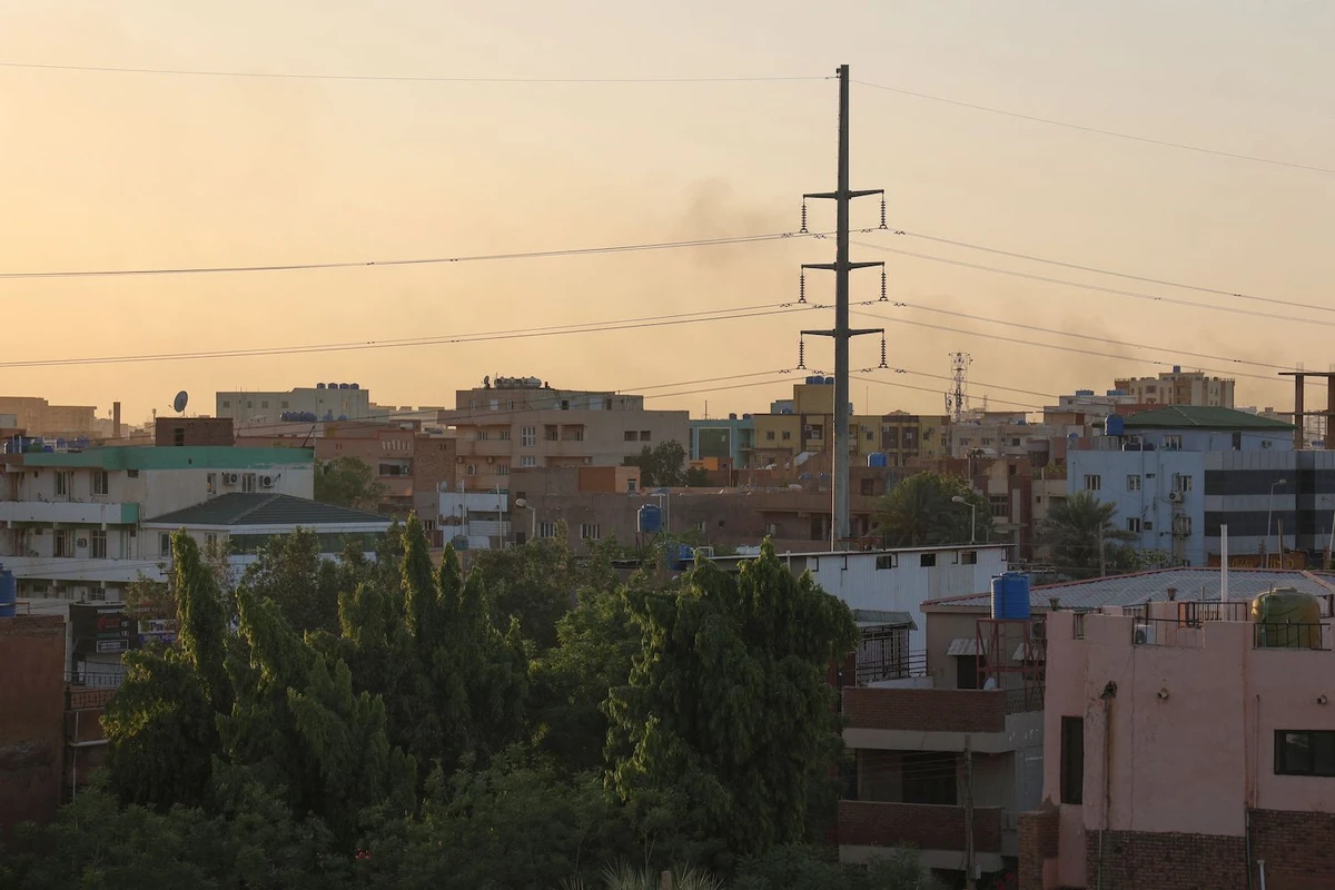 Smoke rises behind buildings in Khartoum on April 19, 2023, amid fighting between the army and paramilitaries following the collapse of a truce. (AFP)