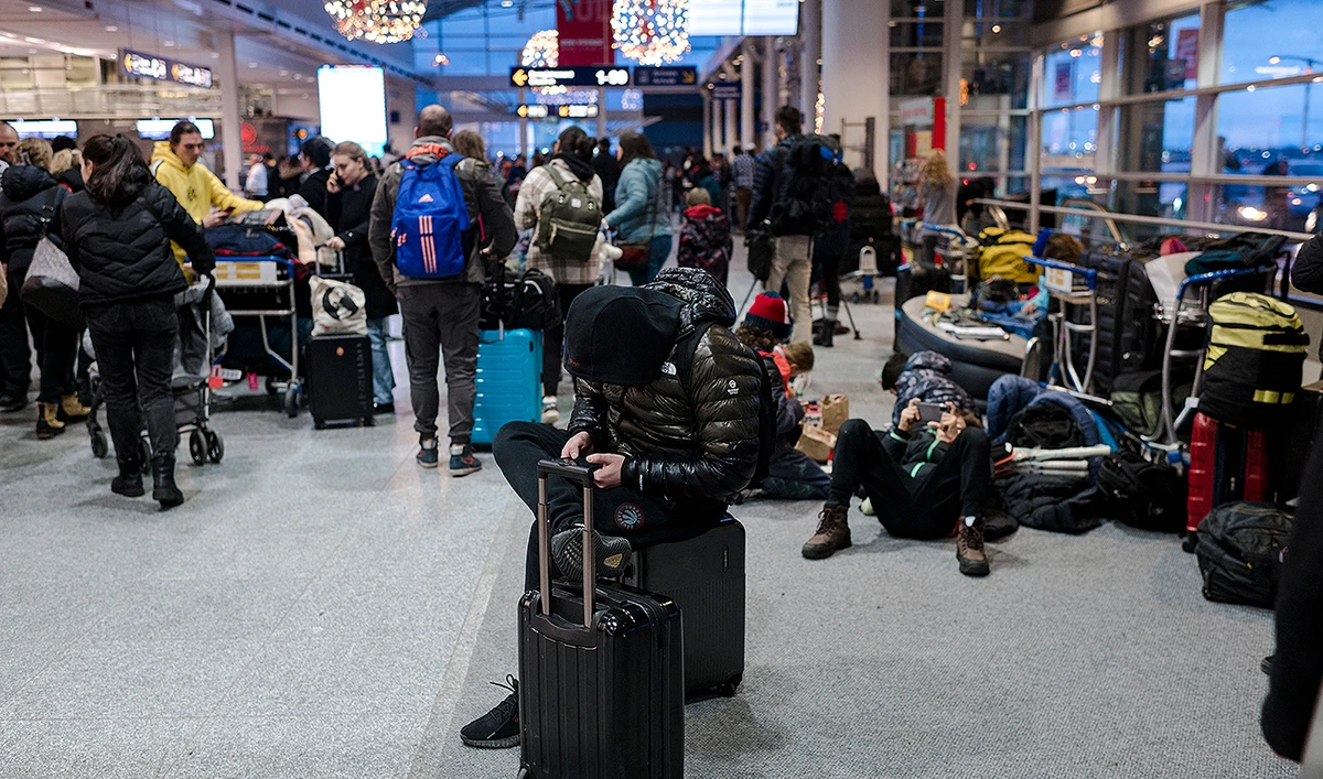 Travelers wait at the Pierre-Elliot Trudeau International Airport in Montreal, Quebec, Canada on December 23, 2022. (Photo courtesy: AFP/File)