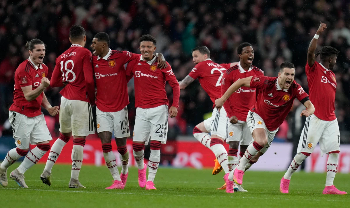 Manchester United players celebrate after winning the English FA Cup semifinal soccer match between Brighton and Hove Albion and Manchester United at Wembley Stadium in London, April 23, 2023. (AP)