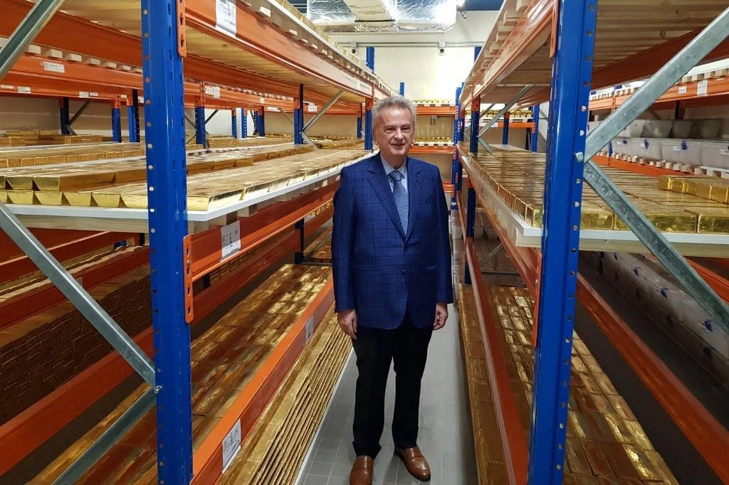 The governor of the Central Bank Riad Salameh stands next to stacks of gold bars on shelves at the bank’s headquarters in the Lebanese capital Beirut. (File/AFP)