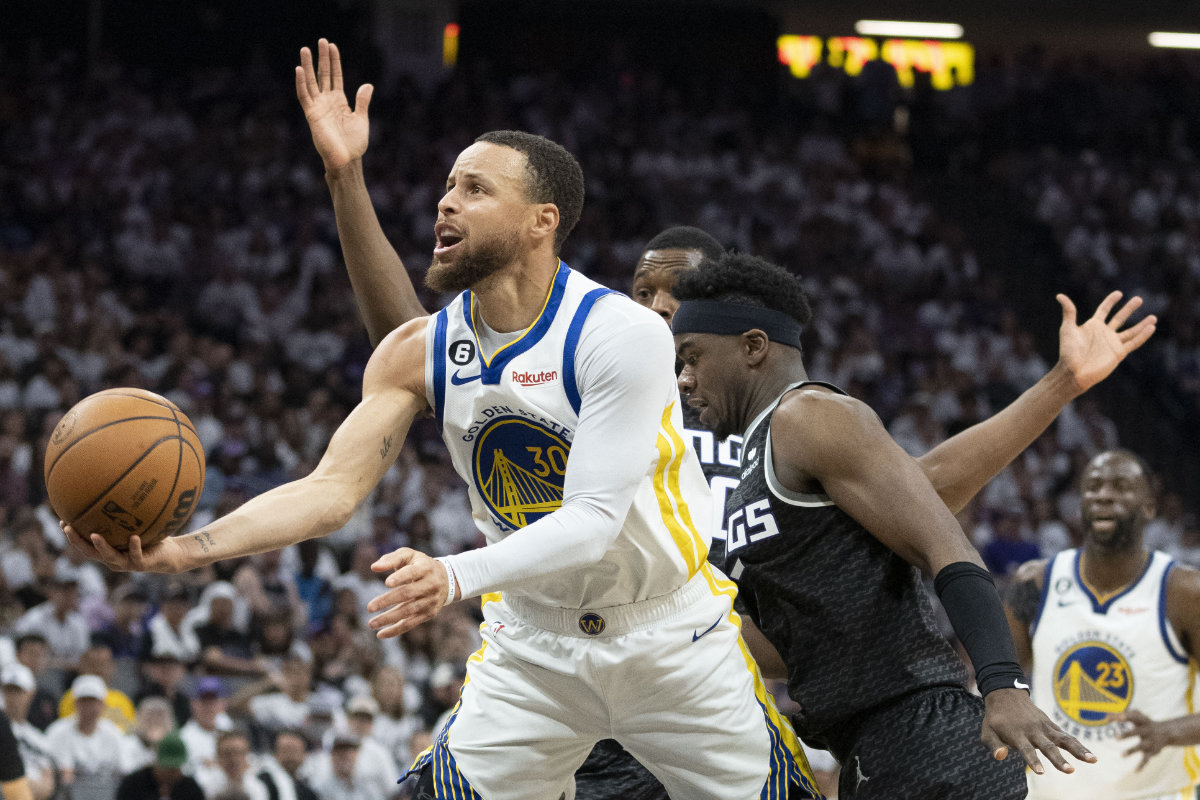Golden State Warriors guard Stephen Curry shoots the basketball against Sacramento Kings forward Harrison Barnes and guard Terence Davis during the third quarter in Game 7 of the 2023 NBA playoffs first round at Golden 1 Center. (USA TODAY Sports)