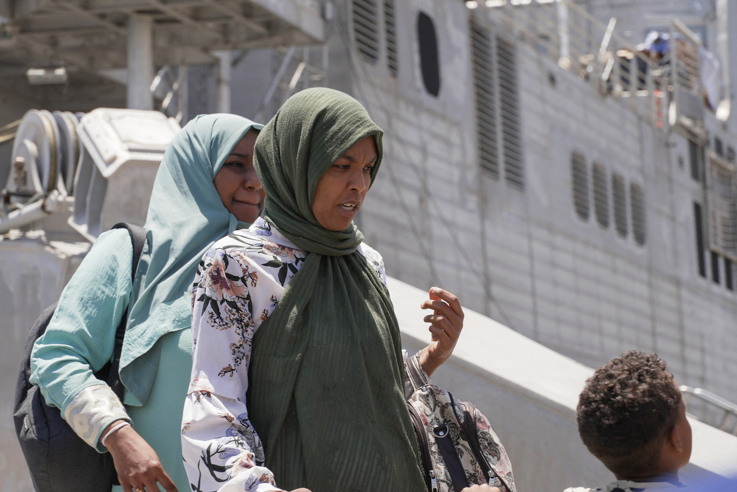 US citizens and other nationalities disembark from a US Navy fast transport ship to escape the conflict, at the Jeddah Sea Port, Jeddah, Saudi Arabia, on May 1, 2023. (Reuters)