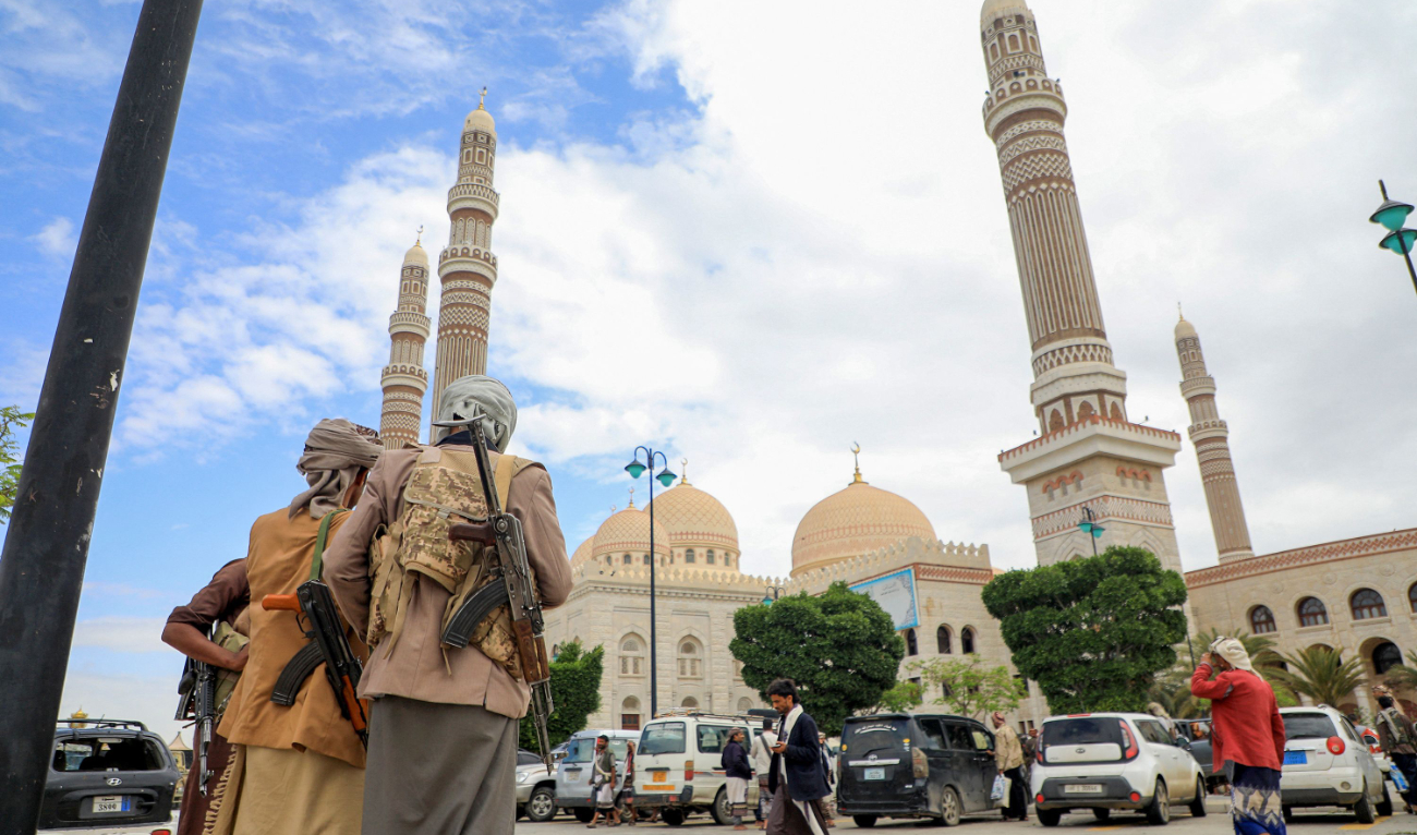 Gunmen stand in front of the Al-Saleh Mosque in Sanaa on Sunday. (AFP)