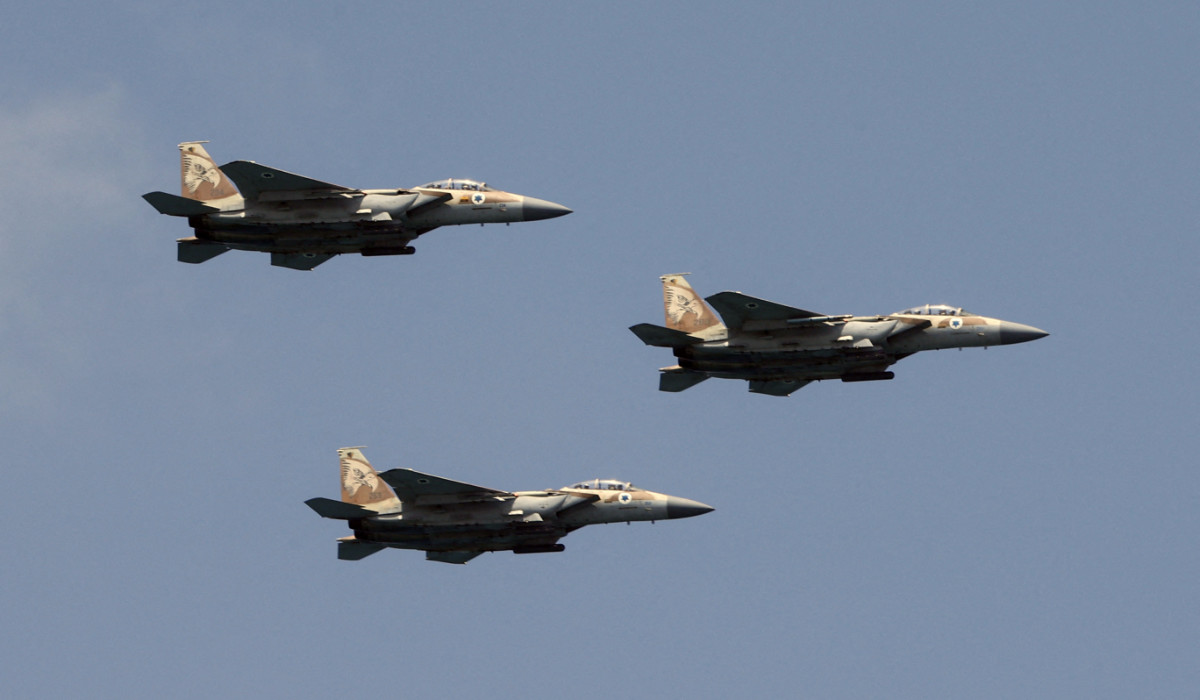 Israeli F-15 fighter jets perform during an air show over the beach in the Israeli coastal city of Tel Aviv on May 5, 2022. (AFP)