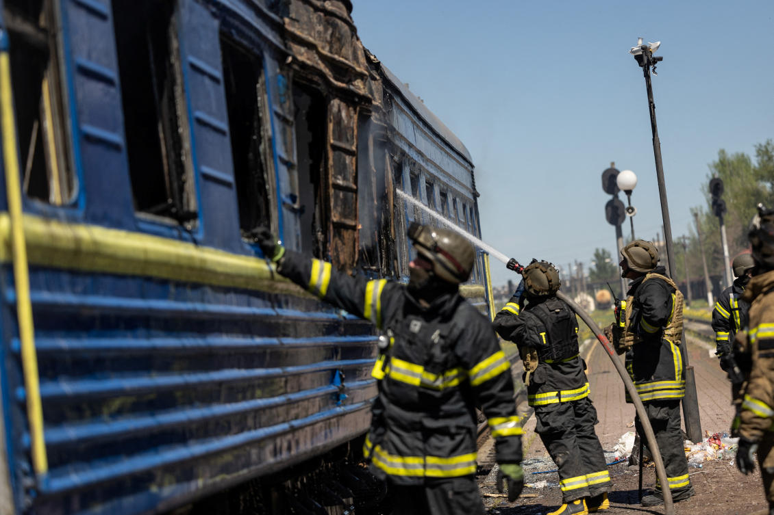 Firefighters work at the site of a train station hit by a Russian military strike, amid Russia’s attack on Ukraine, in Kherson, Ukraine May 3, 2023. (Reuters)