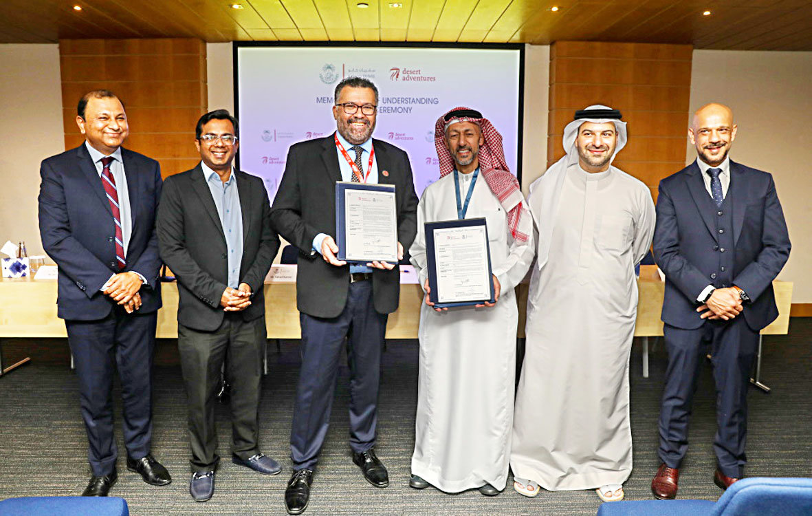 Peter Payet, CEO of Desert Adventures, third from left, and Ali Abdulla Kanoo, deputy chairman of Yusuf Bin Ahmed Kanoo Company Ltd., fourth from left.