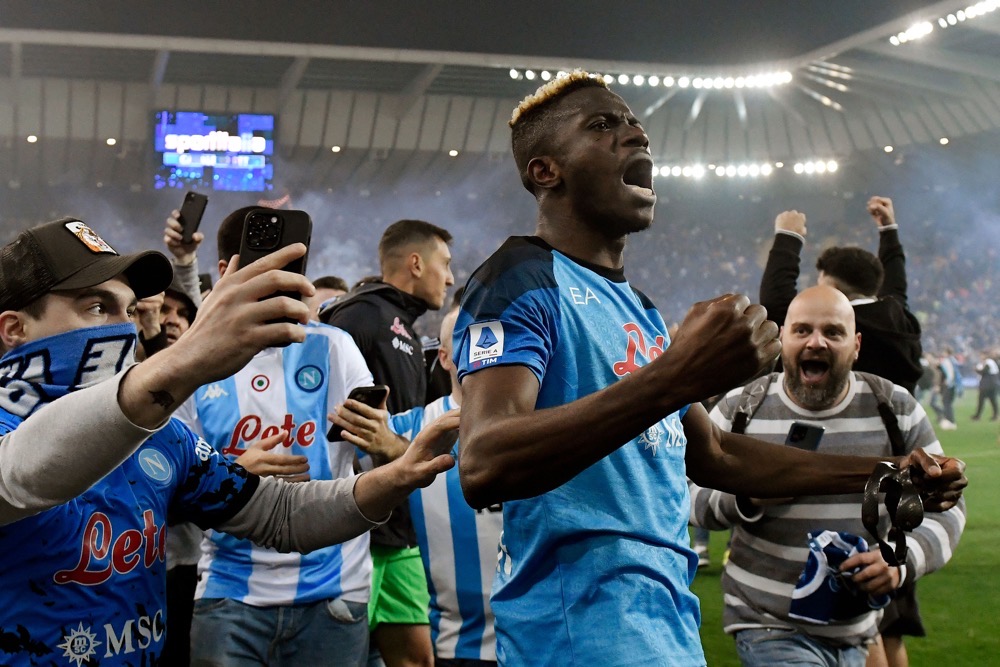 Napoli fans join Victor Osimhen as he celebrates after Napoli secured the Serie A title. (AFP)