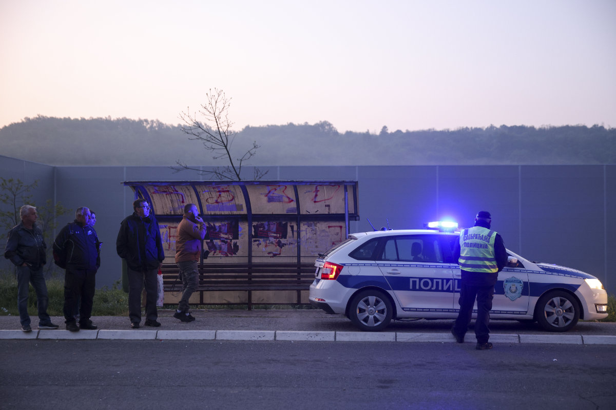 Police officers block the road near the village of Mali Pozarevac, some 50 kilometers south of Belgrade, on May 5, 2023 where a random shooting took place. (AP)