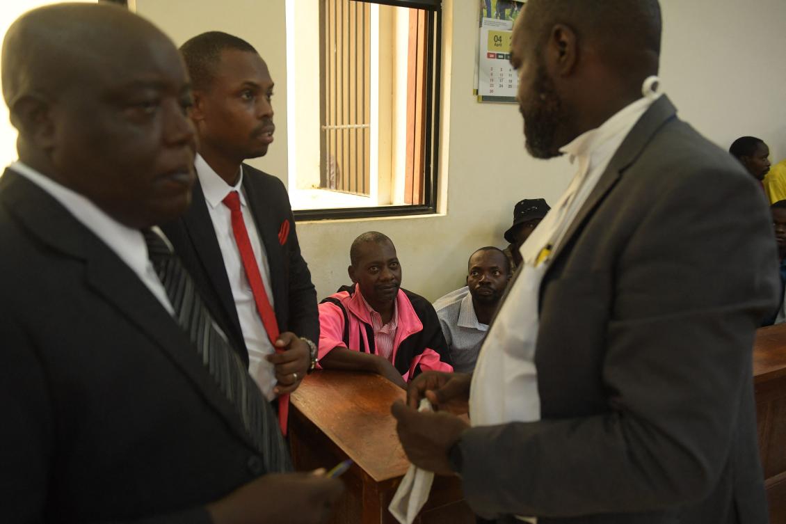 Self-proclaimed pastor Paul Nthenge Mackenzie, center, who set up the Good News International Church in 2003, is accused of inciting cult followers to starve to death ‘to meet Jesus.’ (AFP)