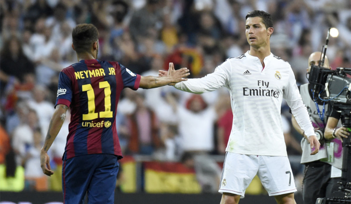 Barcelona's Brazilian forward Neymar da Silva Santos Junior (L) congratulates Real Madrid's Portuguese forward Cristiano Ronaldo on winning after the Spanish league "Clasico" football match Real Madrid CF vs FC Barcelona at the Santiago Bernabeu stadium in Madrid on October 25, 2014. Real Madrid won the match 3-1. (AFP)