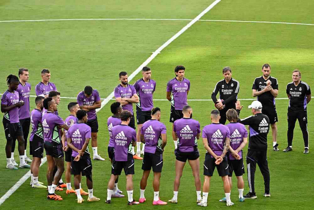 Real Madrid's Italian coach Carlo Ancelotti (Front-R) talks to his players during a training session at la Cartuja stadium in Seville on Friday, on the eve of the Spanish Copa del Rey (King's Cup) final football match between Real Madrid and Osasuna. (AFP)