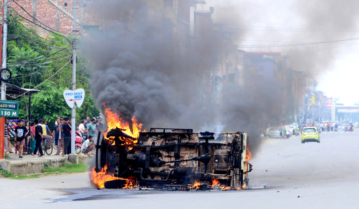 In this picture taken on May 4, 2023, smoke billows from a vehicle allegedly burned by the Meitei community tribals protesting to demand inclusion under the Scheduled Tribe category, in Imphal the capital of India's Manipur state. (AFP)