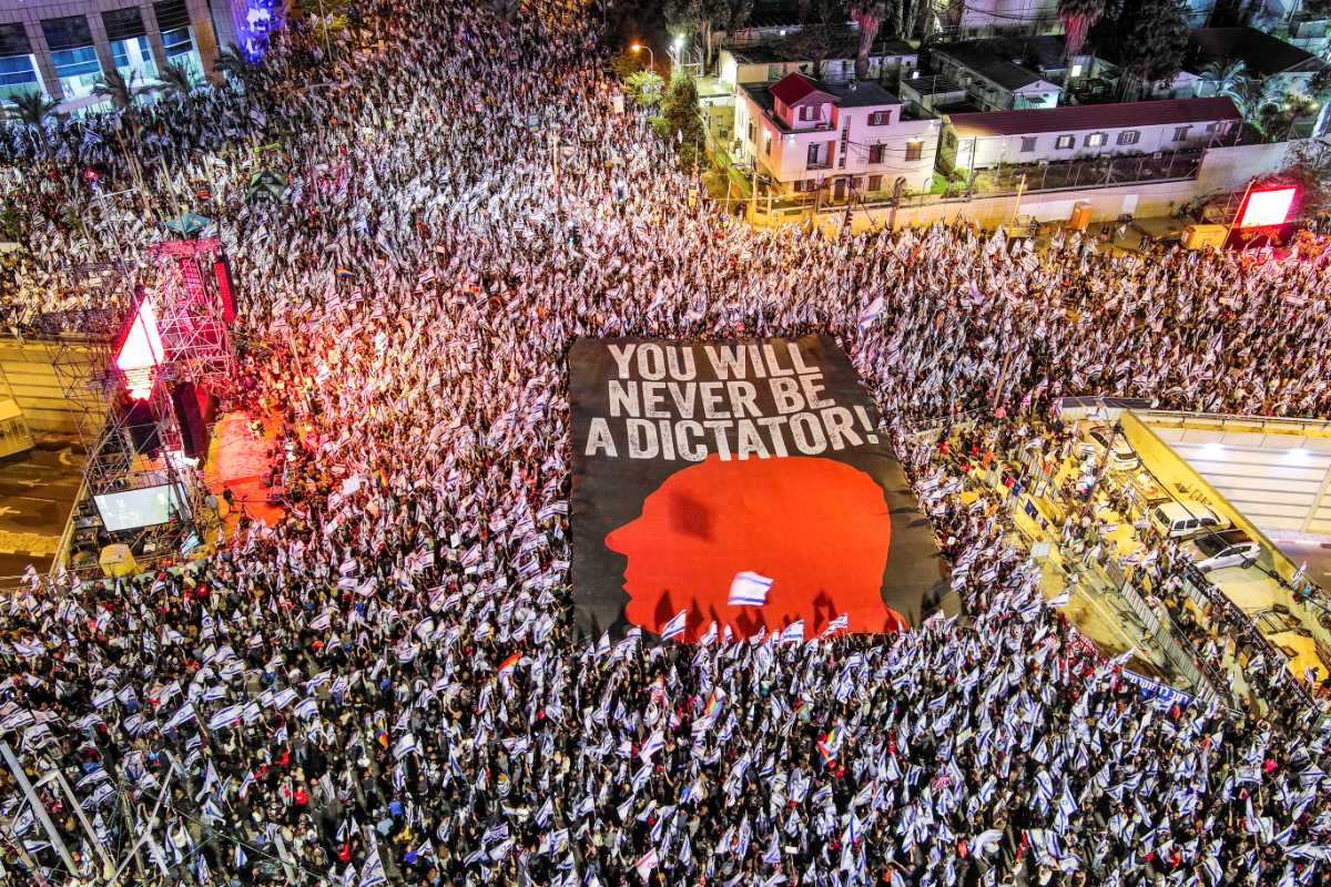 An aerial view shows protesters holding a sign with the silhouette of the face of Israeli Prime Minister Benjamin Netanyahu, as they take part in a demonstration against Israel's nationalist coalition government's judicial overhaul, in Tel Aviv, Israel May 6, 2023. (REUTERS)