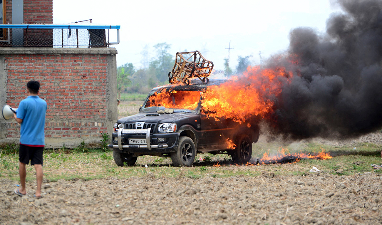 In this picture taken on May 4, 2023, smoke billows from a vehicle allegedly burned by the Meitei community tribals protesting to demand inclusion under the Scheduled Tribe category, in Imphal the capital of India's Manipur state. (AFP)