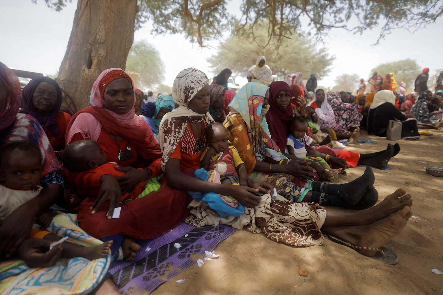 Sudanese refugees wait for medical consultation at Premiere Urgence International clinic near the border between Sudan and Chad in Koufroun. (AFP)