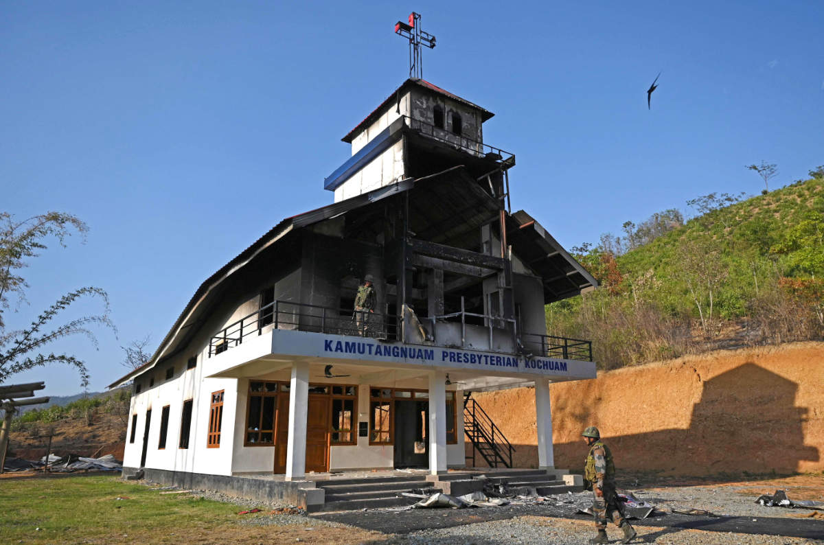 Indian army soldiers inspect the debris of a ransacked church that was set on fire by a mob in the ethnic violence hit area of Senapati district in India's Manipur state on May 8, 2023. (AFP)