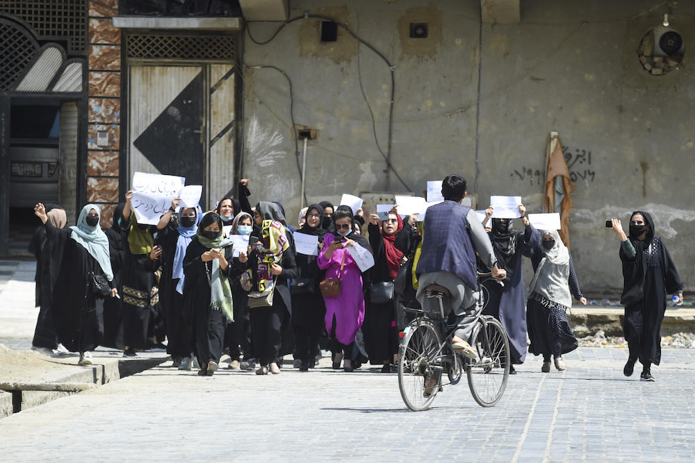 Taliban authorities continued to crack down on dissenting voices this year, in particular those who speak out on issues related to the rights of women and girls. Above, Afghan women protest in Kabul to voice opposition to foreign nations formally recognizing the Taliban government. (AFP)