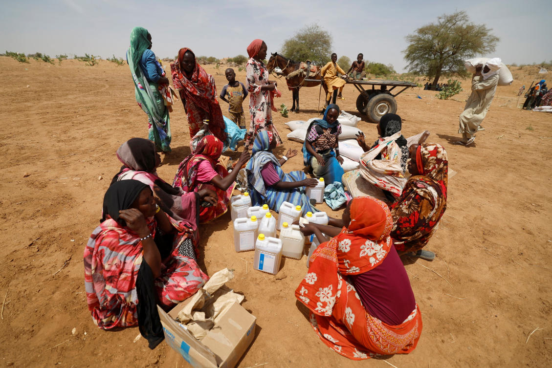 Sudanese refugees, who have fled the violence in their country, sit after they received the food rations from World Food Programme (WFP), which they have to share equally, near the border between Sudan and Chad, in Koufroun, Chad May 9, 2023. (Reuters)