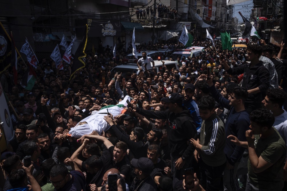 Image Caption : Mourners carry the bodies of Palestinians who were killed in Israeli airstrikes, during their funeral in Gaza City, Tuesday, May 9, 2023. (AP)