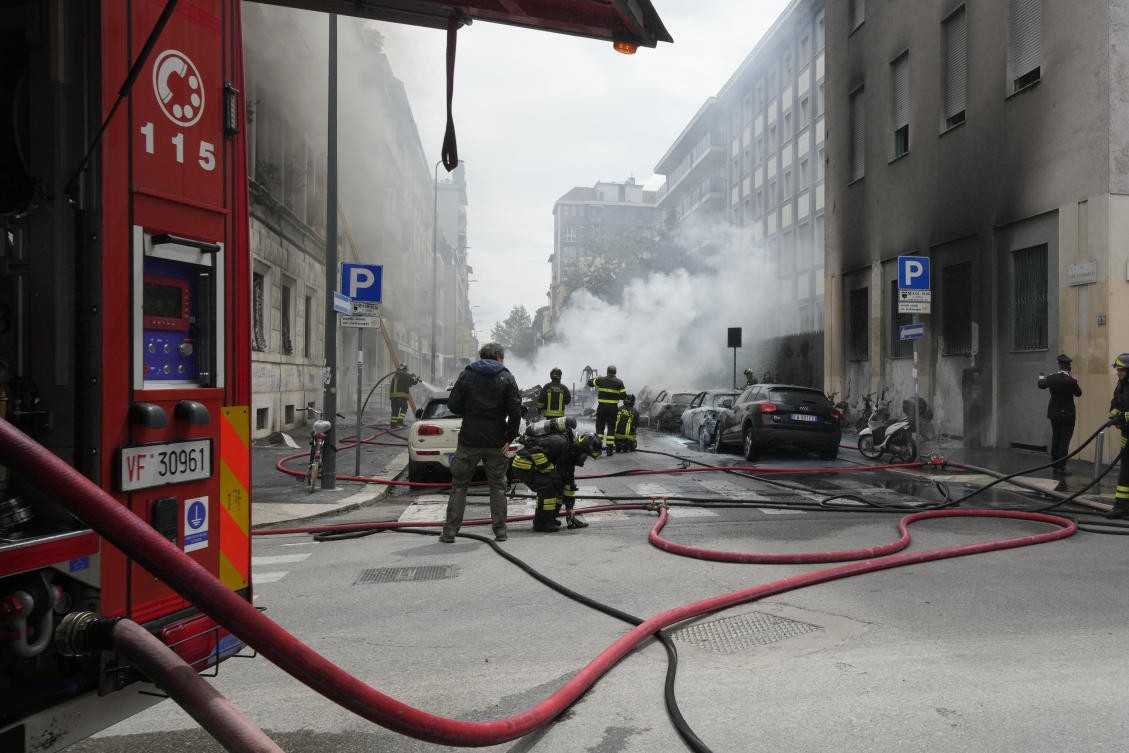 Firefighters work to extinguish a fire in a building after a van exploded in central Milan, northern Italy on May 11, 2023. (AP)