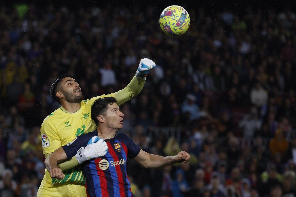 Betis’ goalkeeper Rui Silva clears the ball in front Barcelona’s Robert Lewandowski during their Spanish La Liga match at the Camp Nou stadium in Barcelona on Apr. 29, 2023. (AP/File)