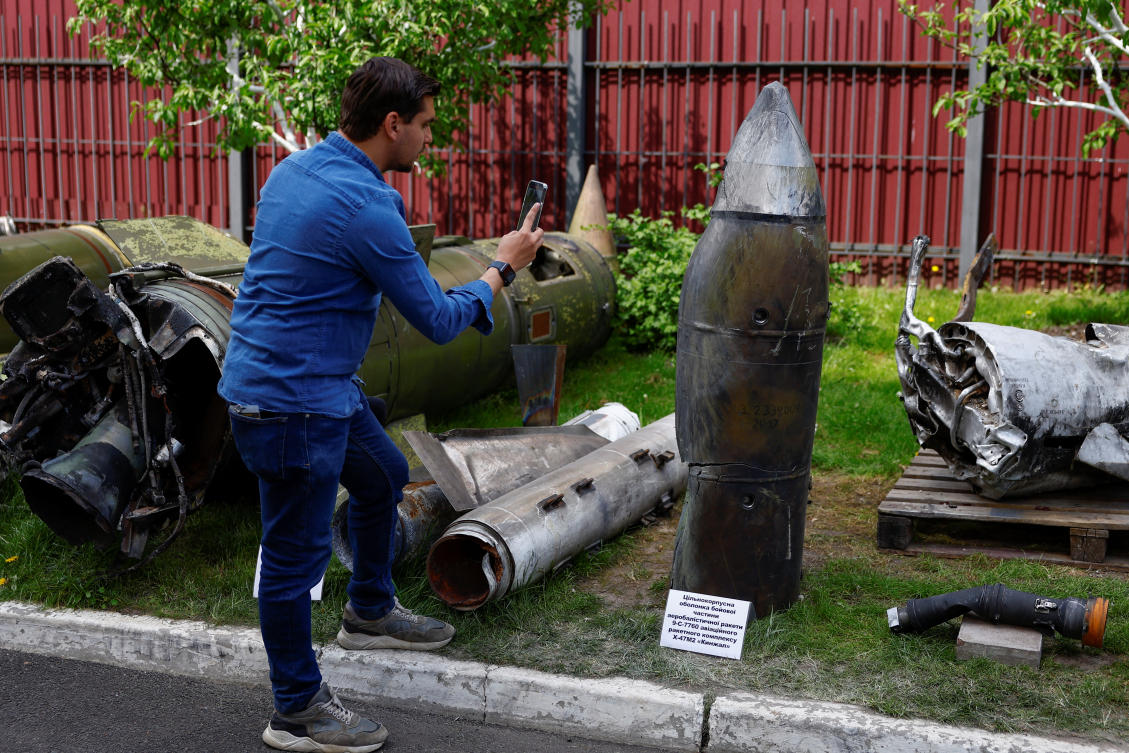 A journalist takes a picture of a Kh-47 Kinzhal Russian hypersonic missile warhead, shot down by a Ukrainian Air Defense unit at a compound of the Scientific Research Institute in Kyiv on May 12, 2023. (Reuters)