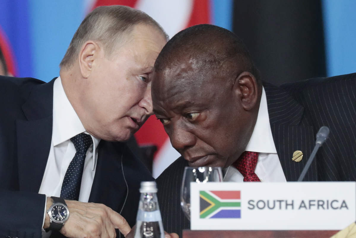 Russian President Vladimir Putin, left, speaks to South African President, Cyril Ramaphosa, right, during a plenary session at the Russia-Africa summit in the Black Sea resort of Sochi, Russia on Oct. 24, 2019. (AP)