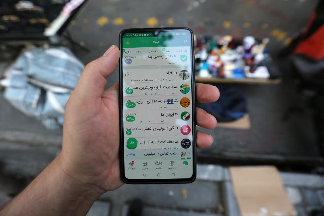 A man shows the Iranian massaging app (Bale) on his mobile telephone in Tehran. The popularity of Iran's domestic messaging apps has boomed since authorities imposed crippling restrictions on the country's internet, but users are also circumventing restrictions and logging on to blacklisted apps and websites.(AFP)