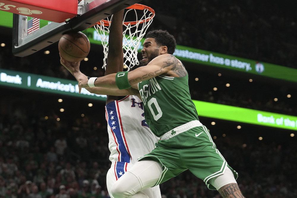 Boston Celtics forward Jayson Tatum (0) drives toward the basket as Philadelphia 76ers center Joel Embiid, behind, defends during the second half of Game 7 in the NBA basketball Eastern Conference semifinals playoff series, Sunday, in Boston. (AP)