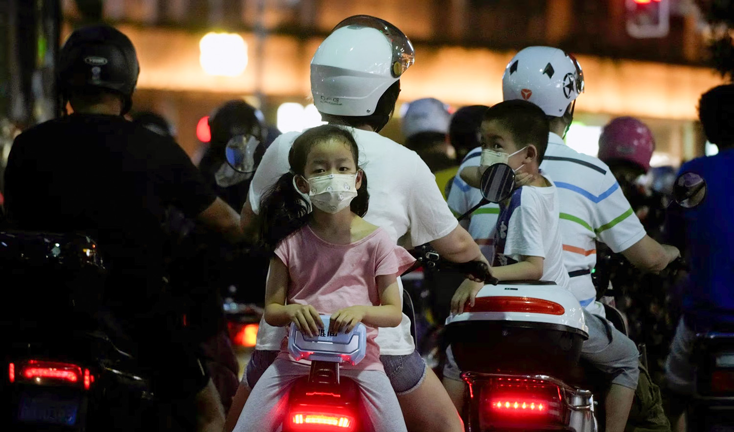 A child is carried on a scooter, following the coronavirus disease (COVID-19) outbreak, in Shanghai, China on July 20, 2022. (REUTERS)