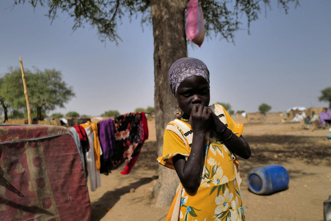 Khadeedja, 7, a Sudanese refugee who has fled the violence in Sudan's Darfur region, looks on as she stands by her shelter, near the border between Sudan and Chad in Koufroun. (File/Reuters)
